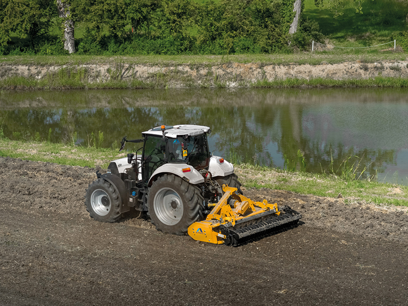 Rigid Alpego Power Harrow working near pond